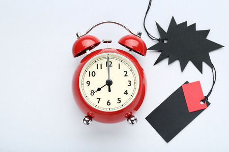 Black sale tags with alarm clock on grey backgroundの写真素材