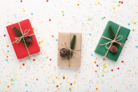 Christmas gift boxes with colorful sprinkles on white backgroundの写真素材