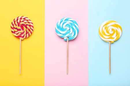 Sweet lollipops on colorful background