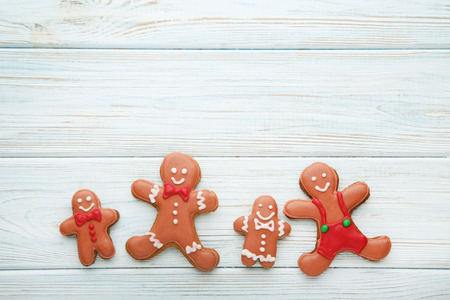 Christmas gingerbread cookies on white wooden tableの写真素材