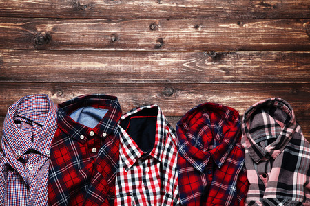 Colorful shirts on brown wooden tableの写真素材