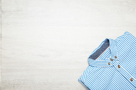 Folded shirt on wooden tableの写真素材