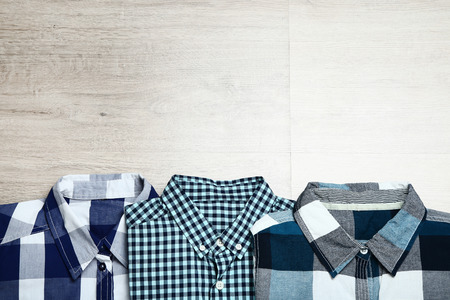 Folded shirts on wooden tableの写真素材