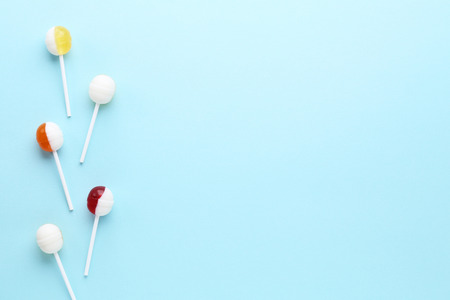 Sweet lollipops on blue backgroundの写真素材
