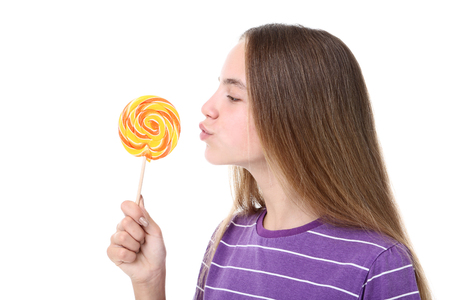 Young girl with lollipop on white backgroundの写真素材