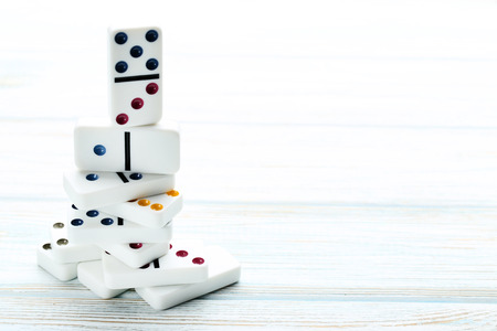 Dominoes on white wooden tableの写真素材