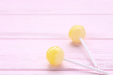 Sweet lollipops on pink wooden tableの写真素材