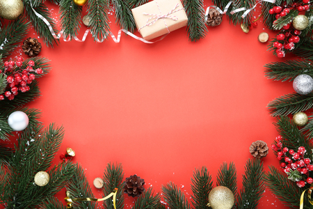 Christmas decorations with fir tree branches on red backgroundの写真素材