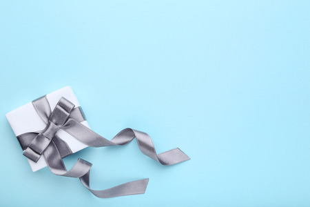 Gift box with ribbon on blue backgroundの写真素材