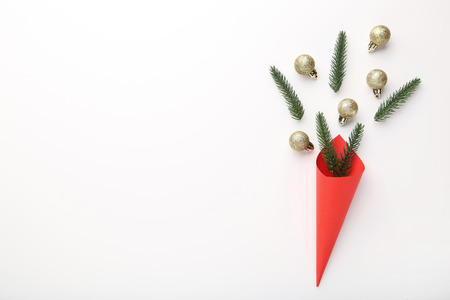 Fir tree branches with golden baubles on white backgroundの写真素材
