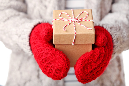 Female hands holding gift box with ropeの写真素材