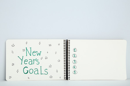 New year goals in notepad on grey backgroundの写真素材