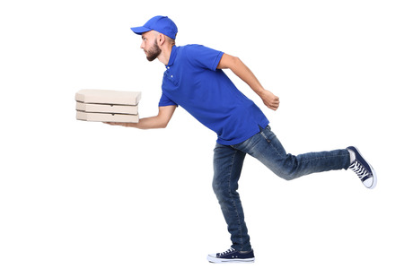 Delivery man with pizza in cardboard boxes isolated on white backgroundの写真素材