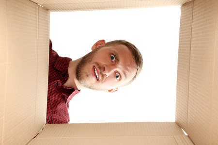 Young man looking inside the box