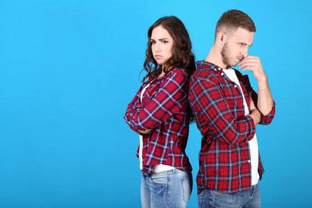 Beautiful young couple on blue backgroundの写真素材