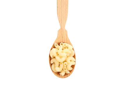 Uncooked pasta in wooden spoon isolated on white backgroundの写真素材