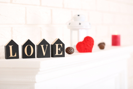 Word Love with cone and red heart on white fireplaceの写真素材