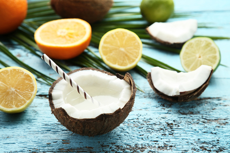 Coconut water with citrus fruits on blue wooden tableの写真素材