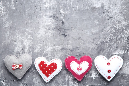 Colorful fabric hearts on grey wooden tableの写真素材