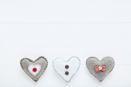 Fabric hearts on white wooden tableの写真素材
