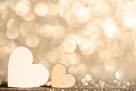 Wooden hearts on bokeh lights backgroundの写真素材