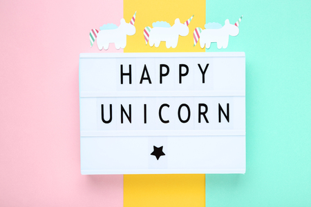 Lightbox with words Happy Unicorn on colorful backgroundの写真素材