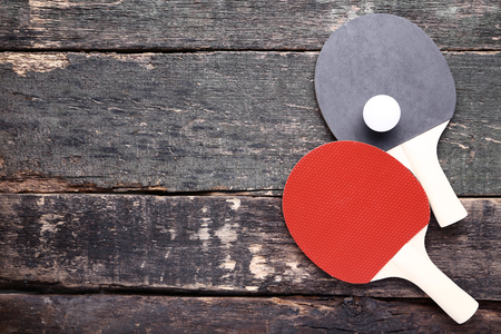 Table tennis rackets with ball on grey wooden tableの写真素材