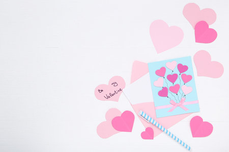Inscription Be My Valentine with paper hearts and envelope on white backgroundの写真素材