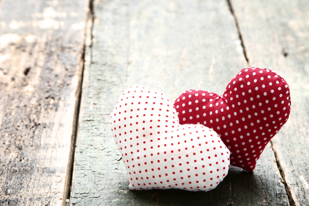 Red and white fabric hearts on wooden tableの写真素材