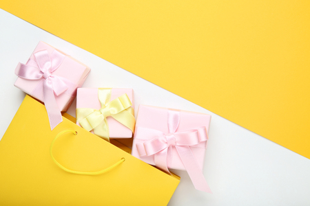 Shopping bag with gift boxes on colorful backgroundの写真素材