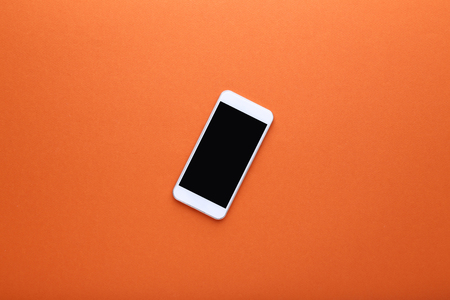 Smartphone on orange backgroundの写真素材