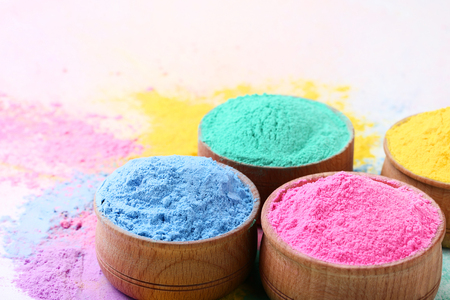 Colorful holi powder in bowls on white backgroundの写真素材