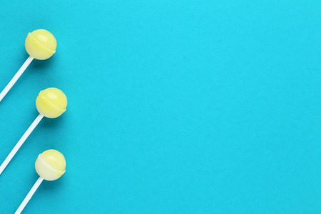Yellow lollipops on blue backgroundの写真素材