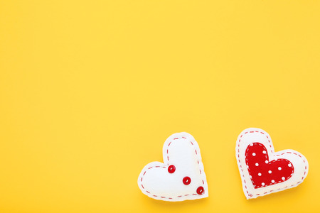 Fabric hearts on yellow backgroundの写真素材