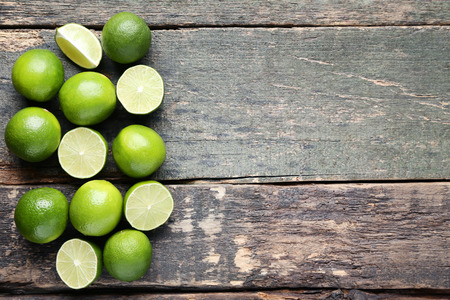 Ripe limes on grey wooden tableの写真素材