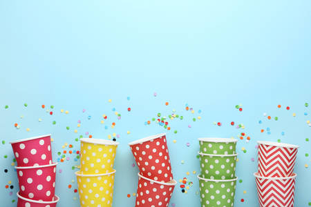 Colorful paper cups on blue backgroundの写真素材