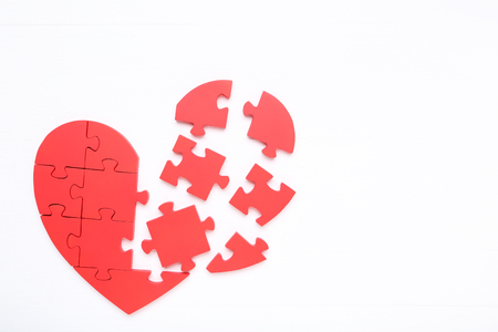 Puzzle heart on white wooden tableの写真素材