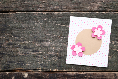 Handmade greeting card with paper flowers on grey wooden tableの写真素材