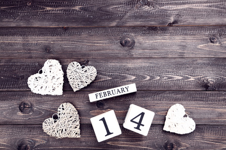 Valentine day on wooden blocks with grey and white heartsの写真素材