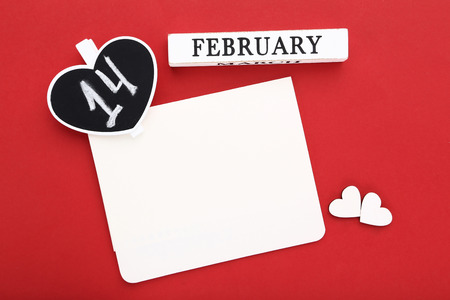 Valentine day with white hearts and blank sheet of paper on red backgroundの写真素材