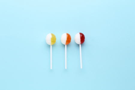 Sweet lollipops on blue background