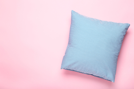 Soft blue pillow on pink backgroundの写真素材