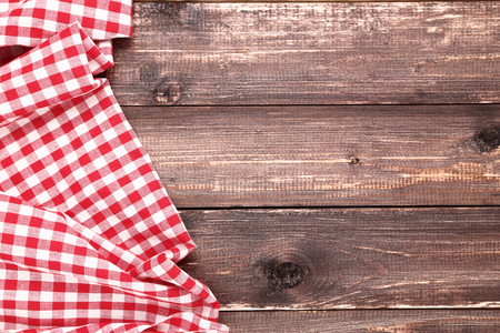 Red napkin on brown wooden tableの写真素材
