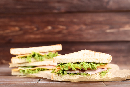 Tasty sandwiches on brown wooden backgroundの写真素材
