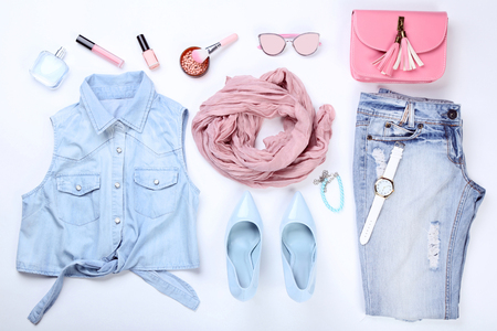Stylish women's clothes with makeup cosmetics and accessories on white backgroundの写真素材