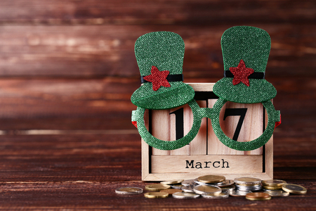 Clover leaf with wooden calendar and coins in pot isolated on white backgroundの写真素材