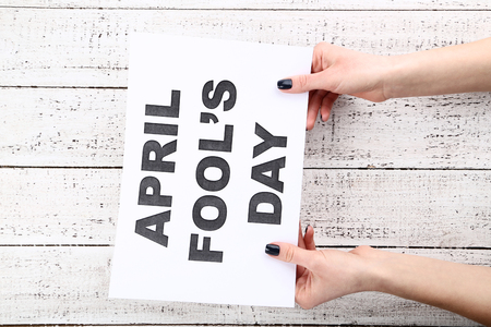 Inscription April Fool's Day on paper in female handsの写真素材