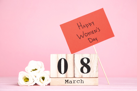 Wooden calendar with eustoma flowers and text Happy Women's Dayの写真素材