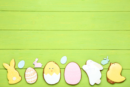 Easter gingerbread cookies on green wooden table