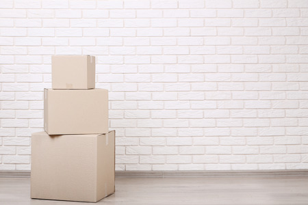 Cardboard boxes on brick wall background